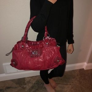 Large, red guess purse.